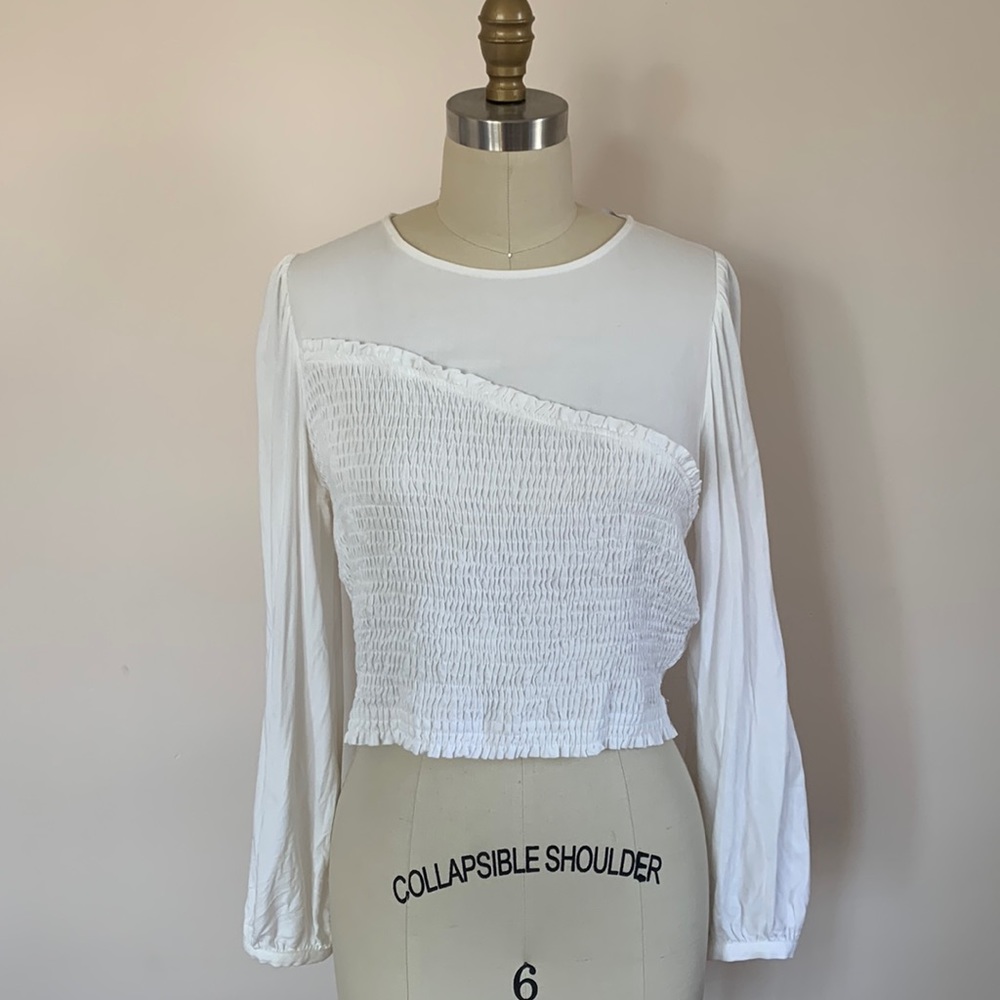 Cream blouse with cropped fit & elastic shirring.